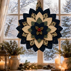 May include: A quilted fabric wall hanging shaped like a large poinsettia flower with layered petals in navy blue, cream, and green, featuring a central cluster of three red berries and green leaves, suspended by a patterned fabric loop.