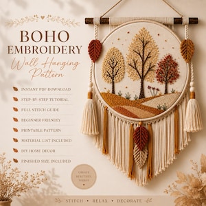 May include: A wall hanging embroidery pattern featuring a circular hoop with a stitched autumn landscape of trees and hills. The design includes cream-colored macrame fringe, wooden beads, and leaf-shaped accents in shades of brown and orange.