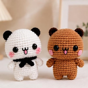 May include: Two small crochet plush toys shaped like animals. One is white with black ears and a black bow tie, the other is brown with dark brown ears. Both have black plastic eyes, pink stitched cheeks, and a mouth with a small pink tongue.
