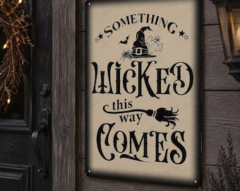 May include: A rectangular metal sign with a beige background and black text that reads SOMETHING WICKED this way COMES. The design features a black witch hat, a small ghost, a spider, a bat, and a broomstick illustration with stars.