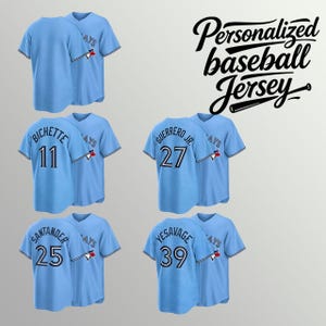 Puede incluir: Camisetas de béisbol azul claro de manga corta con cierre de botones. Cada camiseta presenta un logotipo de equipo en la manga y los nombres y números de los jugadores en la espalda, incluyendo Bichette 11, Guerrero Jr. 27, Santander 25 y Yesavage 39.
