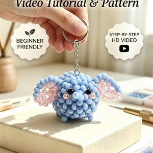 May include: A 3D beaded elephant keyring featuring light blue and pale pink beads, attached to a silver metal ring. The image includes the text: 3D BEADED ELEPHANT KEYCHAIN, Video Tutorial & Pattern, BEGINNER FRIENDLY, STEP-BY-STEP HD VIDEO, INSTANT DIGITAL DOWNLOAD.