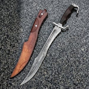 May include: A fixed-blade knife with a patterned Damascus steel blade, a dark wooden handle with a curved pommel, and a silver-toned metal guard. Beside the knife lies a tan leather sheath featuring embossed geometric line patterns.