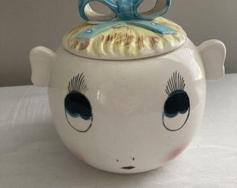Tarro para galletas Royal Sealy vintage con figura de niña antropomórfica y lazo rubio en el pelo, fabricado en Japón.