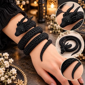 May include: A black crochet dragon bracelet featuring a long, coiled body with a detailed head, pointed ears, and small horns. The flexible, textured yarn design wraps around the arm, showcasing intricate stitching and a tapered tail end.