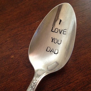 May include: A silver spoon with the words "I Love You Dad" engraved on the bowl.