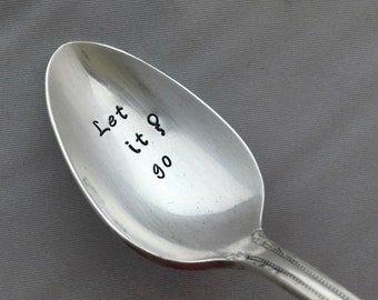 Puede incluir: Una cuchara de plata con la frase "Let it go" grabada en el cuenco.