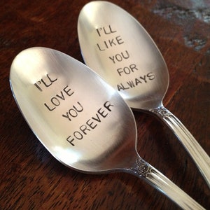 May include: Two silver spoons with engraved messages. The first spoon says "I'll love you forever". The second spoon says "I'll like you for always".