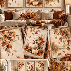 May include: A set of three framed wall art prints featuring autumn themes, including maple leaves, pumpkins, and a lakeside landscape. The artwork displays warm orange, red, and brown tones, presented in light wooden frames for wall display.