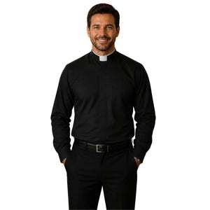 May include: A long-sleeved black clergy shirt featuring a mandarin collar with a white clerical tab insert. The shirt is worn tucked into black trousers held by a black belt with a silver buckle, presenting a formal and uniform appearance.