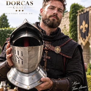 May include: A metallic knight helmet with a visor and ventilation slits, held by a person wearing a black quilted tunic with brown leather straps and a gold fleur-de-lis emblem. The text reads DORCAS CRAFT HISTORY LIVES ON and More Than Armor, A Story.