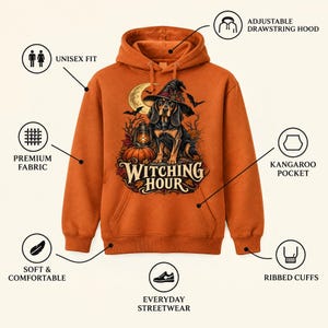 May include: An orange hooded sweatshirt featuring a graphic of a dog wearing a witch hat, a lantern, a pumpkin, and the text "WITCHING HOUR". The hoodie includes an adjustable drawstring hood, a kangaroo pocket, and ribbed cuffs.