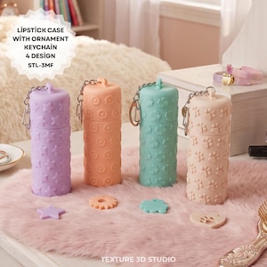 May include: Four cylindrical lipstick cases with attached metal keychain rings, each featuring a distinct embossed pattern: stars, gears, clovers, and paw prints. The cases are lavender, peach, mint green, and beige, with matching loose ornaments.