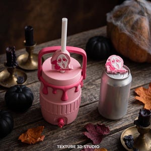 May include: A pink beverage cooler with a handle and a spigot, featuring a pink Ghostface topper with heart eyes and the text DO YOU LIKE SCARY MOVIES. Next to it is a silver aluminum can with a matching pink Ghostface topper on the lid.