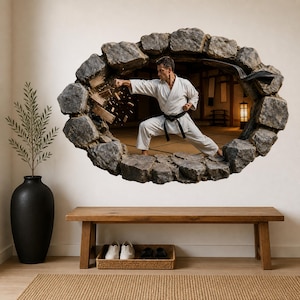 Peut inclure: Un sticker mural représentant un effet trompe-l'œil d'un trou bordé de pierres dans un mur. À l'intérieur de l'ouverture, un pratiquant d'arts martiaux en gi blanc et ceinture noire est représenté en plein coup de poing, brisant des planches.