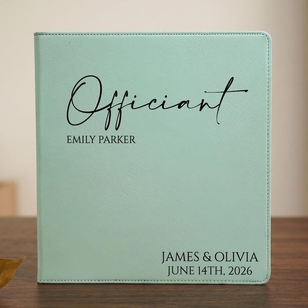 May include: A mint green binder featuring the word Officiant in a black script font, with the name EMILY PARKER printed below. The bottom right corner displays the text JAMES & OLIVIA and the date JUNE 14TH, 2026 in a clean black sans-serif font.
