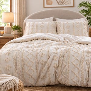 May include: A cream-colored duvet cover and two matching pillow shams featuring a textured tufted pattern of vertical stripes and diamond shapes. The bedding set has a soft, raised fabric design that creates a tactile surface across the entire set.