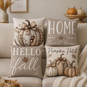 May include: A set of four square throw pillows in neutral beige tones. One features a large pumpkin with a bow, one says HOME Sweet Home with a small pumpkin, one says HELLO fall with a maple leaf, and one says Pumpkin Patch with three pumpkins.