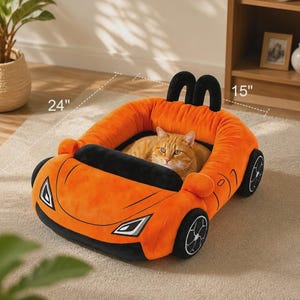 May include: An orange and black plush pet bed shaped like a sports car with a ginger cat resting inside. The bed features black wheels, a black windshield, and two black headrests. It measures 24 inches in length and 15 inches in width.