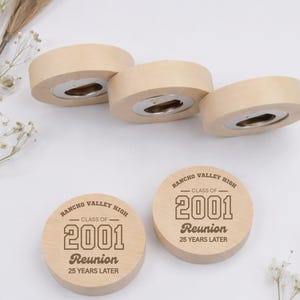 May include: Five round wooden bottle openers with a light tan finish. Three openers show the metal mechanism, while two display the engraved text: Rancho Valley High, Class of 2001, Reunion, 25 Years Later, in a dark brown font.