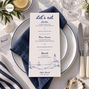 May include: A vertical menu card with dark blue text and nautical illustrations on a light background. The text reads Let's eat, Starter, Main Course, Dessert, and Lily & Daniel 14th June 2027. It features a lighthouse, sailboat, and waves.