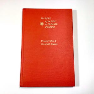 May include: A red hardcover book with the title "The Role of the Sun in Climate Change" and the authors "Douglas V. Hoyt & Kenneth H. Schatten" printed in gold lettering.