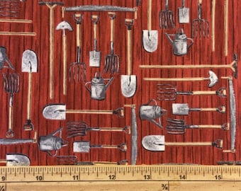 May include: A red and white fabric with a repeating pattern of gardening tools. The tools include shovels, rakes, trowels, and watering cans. The fabric is measured with a ruler in inches.