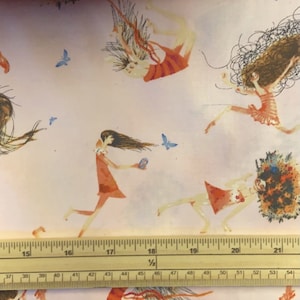 May include: A pink fabric with a repeating pattern of girls with long flowing hair and orange dresses. The girls are in various poses, some are falling, some are running, and some are flying. There are also small blue butterflies scattered throughout the fabric.
