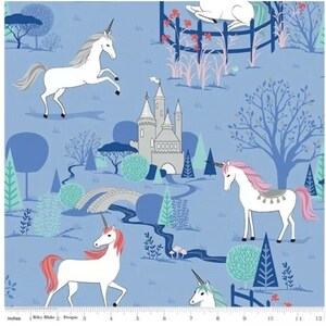 May include: A blue fabric with a repeating pattern of white unicorns, a grey castle, and green trees. The unicorns have pink manes and tails. The castle has a pointed roof and a white door. The trees are stylised and have blue trunks.