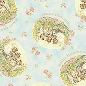 May include: A blue and white fabric with a repeating pattern of three kittens playing in a garden. The kittens are surrounded by flowers and the text "Three Little Kittens" is written around the kittens.