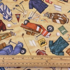 May include: A colourful fabric with a golf theme. It features golf clubs, golf bags, golf carts, golf balls, and golf shirts. The fabric is beige with a brown, red, blue, and green pattern.