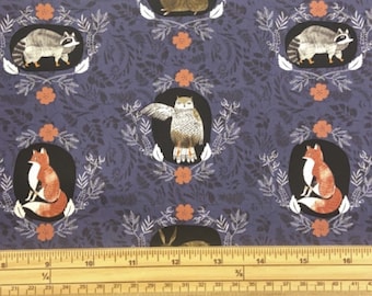 May include: Purple fabric with a repeating pattern of woodland animals in frames. The animals include a fox, owl, raccoon, and rabbit. The frames are made of leaves and flowers.