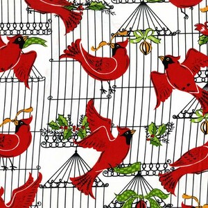 May include: Red cardinals in cages with holly and green bows. The birds are perched on the cages and some are holding a ribbon in their beaks.