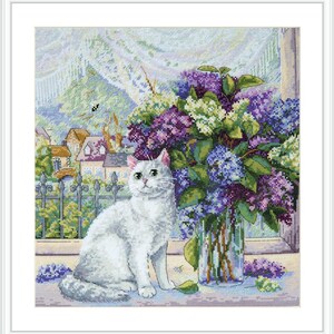 May include: A white cat sits on a windowsill, gazing out at a bouquet of purple and white lilacs in a glass vase. The flowers are in focus, while the cat and the background are slightly blurred.
