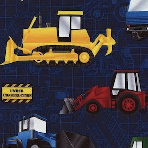 May include: A blue fabric with a repeating pattern of construction vehicles. The vehicles include a yellow bulldozer, a red excavator, a blue dump truck, and a green truck. The fabric has a grid pattern and the words "Under Construction" in yellow.