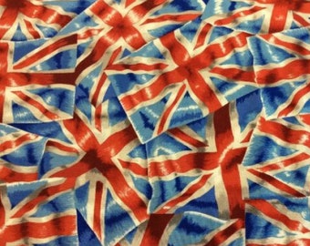 May include: A fabric with a repeating pattern of red, white, and blue Union Jack flags. The flags are overlapping and appear to be made of a soft, textured material.