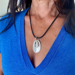 cowrie shell and silver pendant