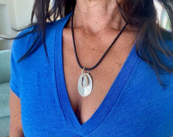 cowrie shell and silver pendant