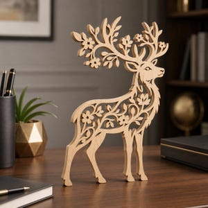 May include: A light brown wooden deer figurine featuring intricate laser-cut details of flowers and leaves integrated into its body and antlers. The cutout design creates a delicate silhouette of a standing deer with floral patterns throughout.