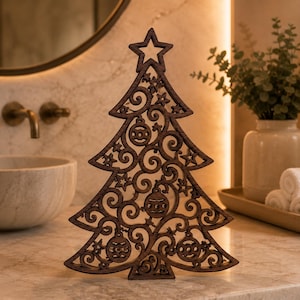 May include: A dark brown wooden Christmas tree decoration featuring intricate laser-cut scrollwork, swirling patterns, and cutout star and ornament shapes. The tree is topped with a five-pointed star and stands on a flat base.