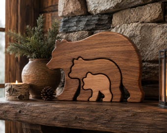 May include: A set of three nested wooden bear figurines carved from smooth, medium-brown wood. The design features a large adult bear silhouette containing a medium-sized bear and a smaller bear cub, all standing in a profile orientation.