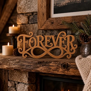 May include: A brown wooden cutout sign featuring the word FOREVER in a decorative script font, with the letters integrated into an infinity symbol shape. The sign has a smooth, matte finish and is designed to stand upright on a flat surface.