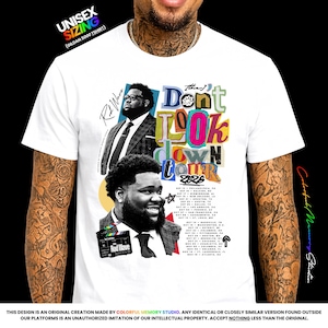 Może przedstawiać: Biały t-shirt z nadrukiem graficznym przedstawiającym Rod Wave'a w garniturze, klaps filmowy oraz napis "Don't Look Down Tour 2026" wraz z listą dat i miast trasy koncertowej. Projekt zawiera kolorową, warstwową typografię oraz podpis.