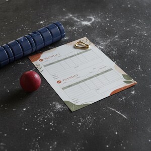 Close-up of gym workout log showing detailed tracking fields for load, rest periods, and body feedback
