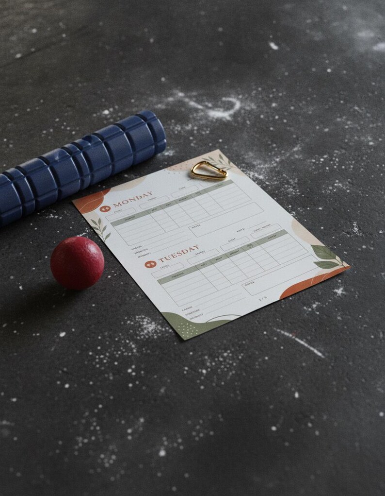 Close-up of gym workout log showing detailed tracking fields for load, rest periods, and body feedback