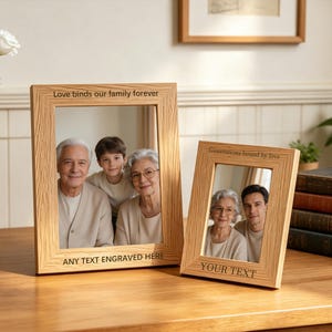 May include: Two light-coloured wooden picture frames with vertical grain. The larger frame features the engraved text "Love binds our family forever" and "ANY TEXT ENGRAVED HERE". The smaller frame features "Generations bound by love" and "YOUR TEXT".