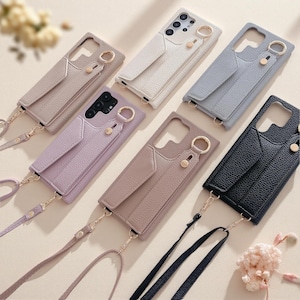 May include: Six smartphone cases with a textured finish, each featuring an integrated card pocket, a circular metal ring attachment, and a matching detachable crossbody strap. The cases are available in beige, white, light blue, lavender, tan, and black.