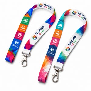 Może przedstawiać: Dwie smycze z białym tłem oraz kolorowymi wzorami geometrycznymi i akwarelowymi. Każda taśma zawiera napis Together We Can oraz ikony i etykiety Community, Volunteer, Donate i Make a Difference.