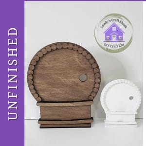 May include: A DIY Paint Kit featuring two circular wooden snow globe cutouts with beaded borders and small circular openings. One cutout is natural brown wood, and the other is painted white. The text DIY Paint Kit and UNFINISHED is visible.