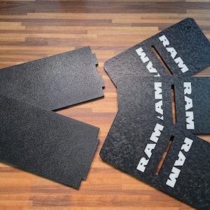 May include: A set of black rectangular panels with a textured surface. Three of the panels feature a vertical slot and the white text RAM printed vertically. Two additional plain black panels are included, each with small side notches.